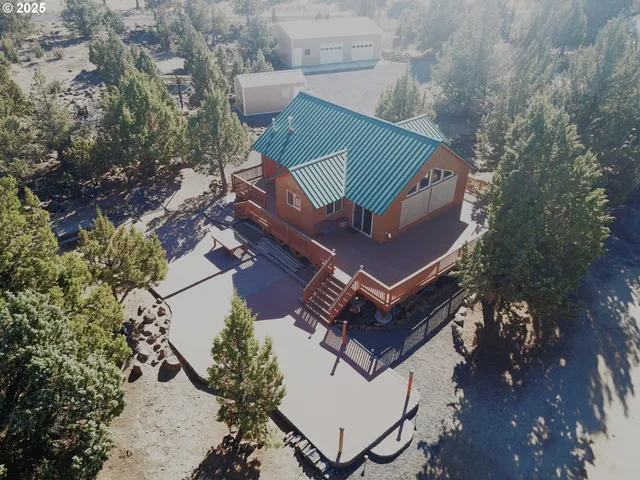 an aerial view of a house with a yard