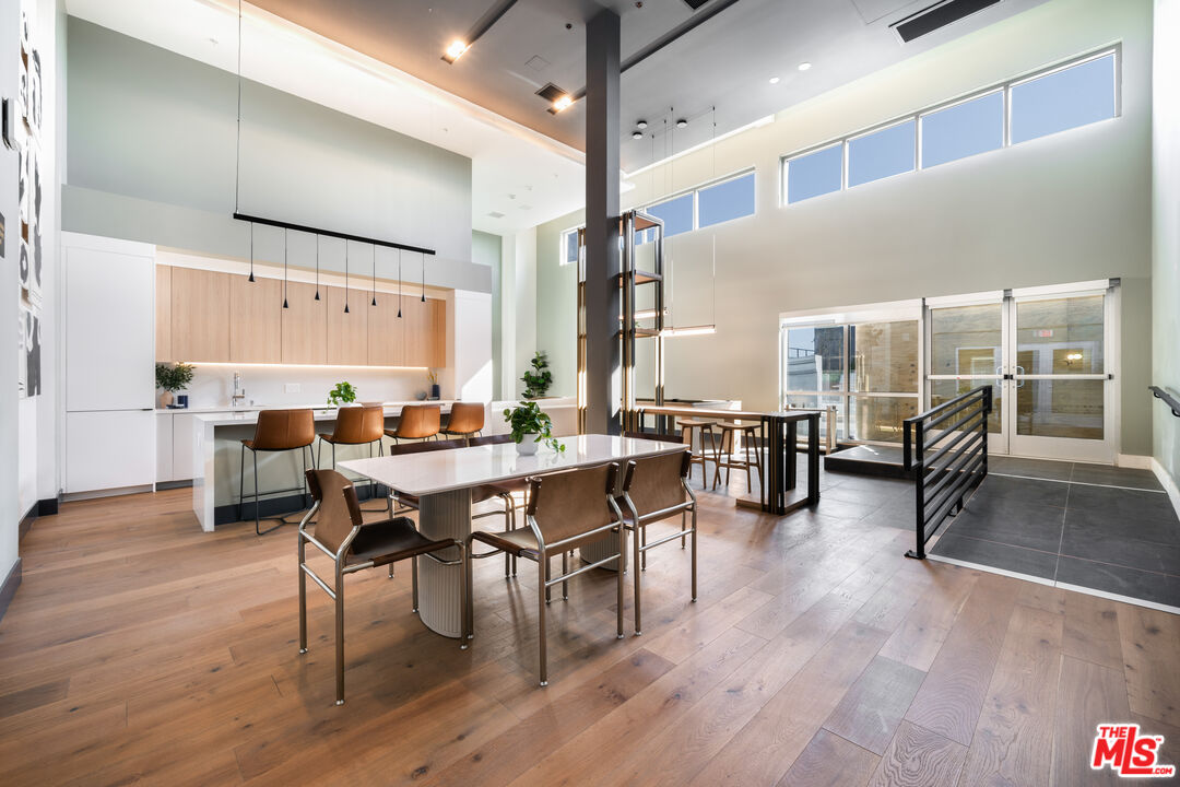 800 Western Avenue, Unit 510 Los Angeles, CA 90005 - Photo 13 of 26 a view of a dining room with furniture and wooden floor