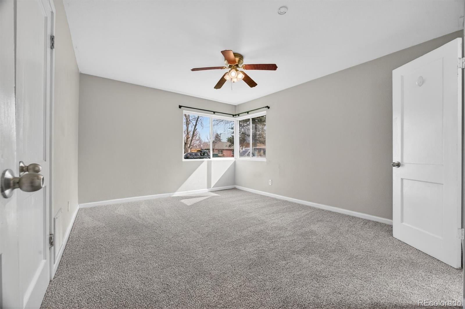 901 Racine Street Aurora, CO 80011 - Photo 12 of 29 wooden floor in an empty room with a window