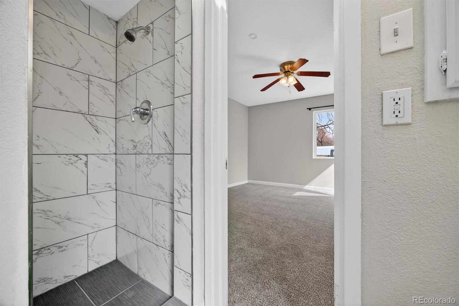 901 Racine Street Aurora, CO 80011 - Photo 15 of 29 a bathroom with a shower
