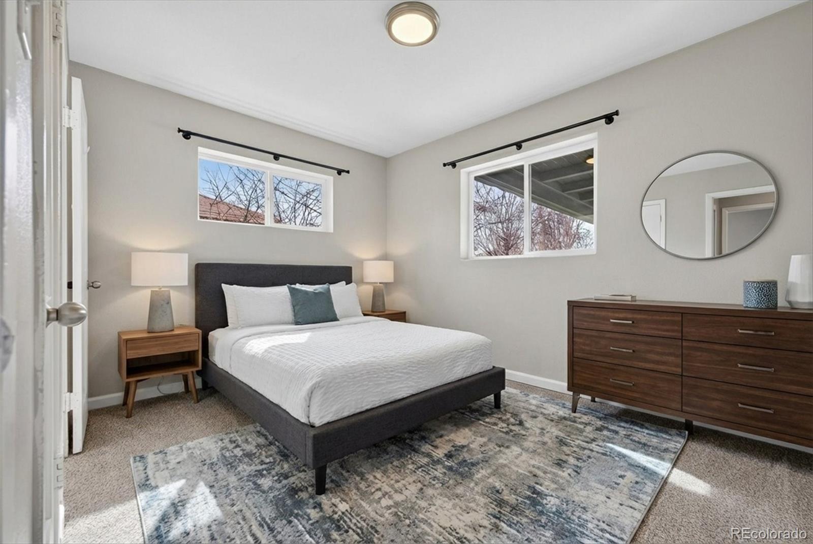 901 Racine Street Aurora, CO 80011 - Photo 17 of 29 a bedroom with a bed and a painting on the wall