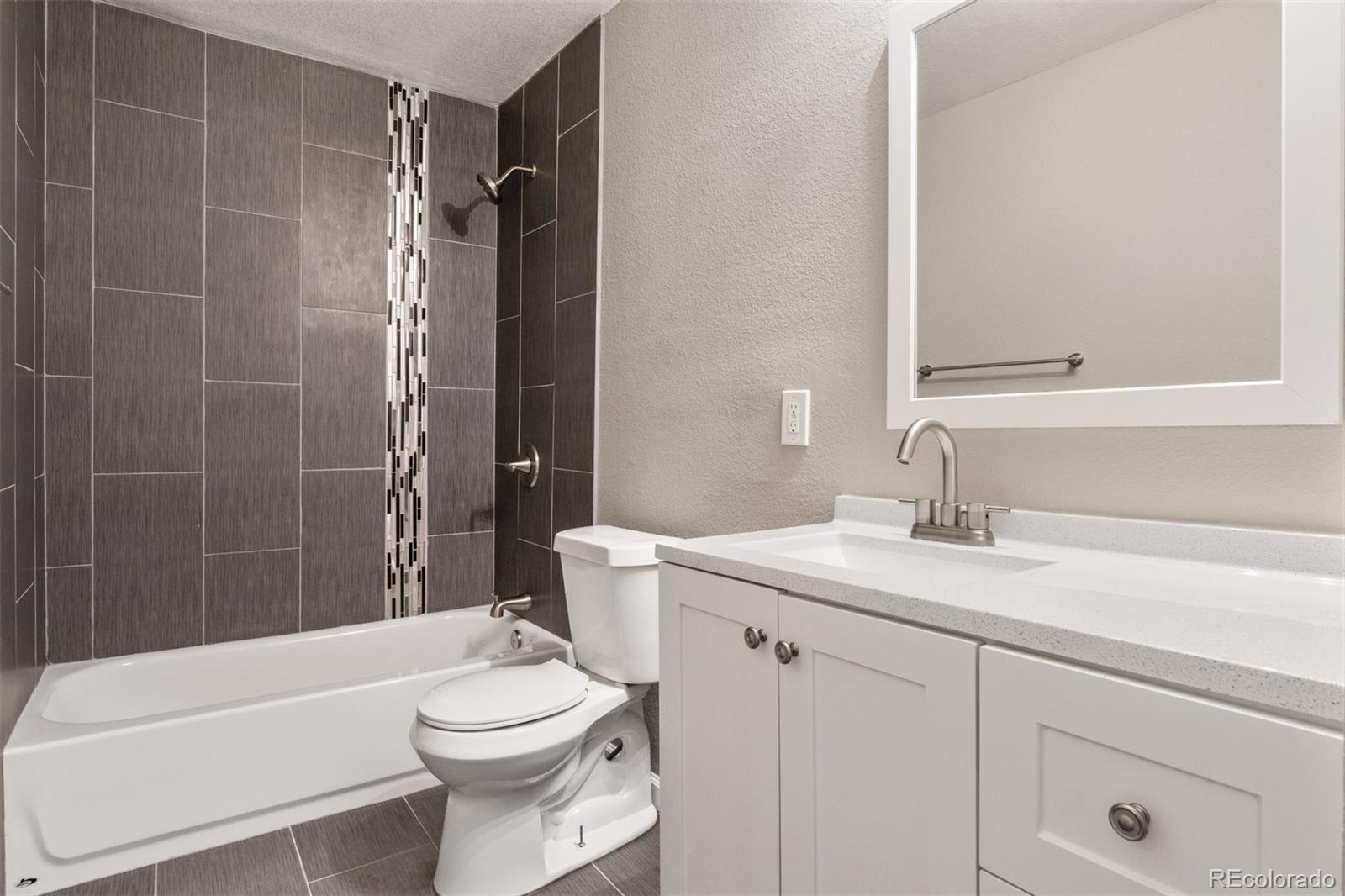 901 Racine Street Aurora, CO 80011 - Photo 19 of 29 a bathroom with a sink a toilet and shower
