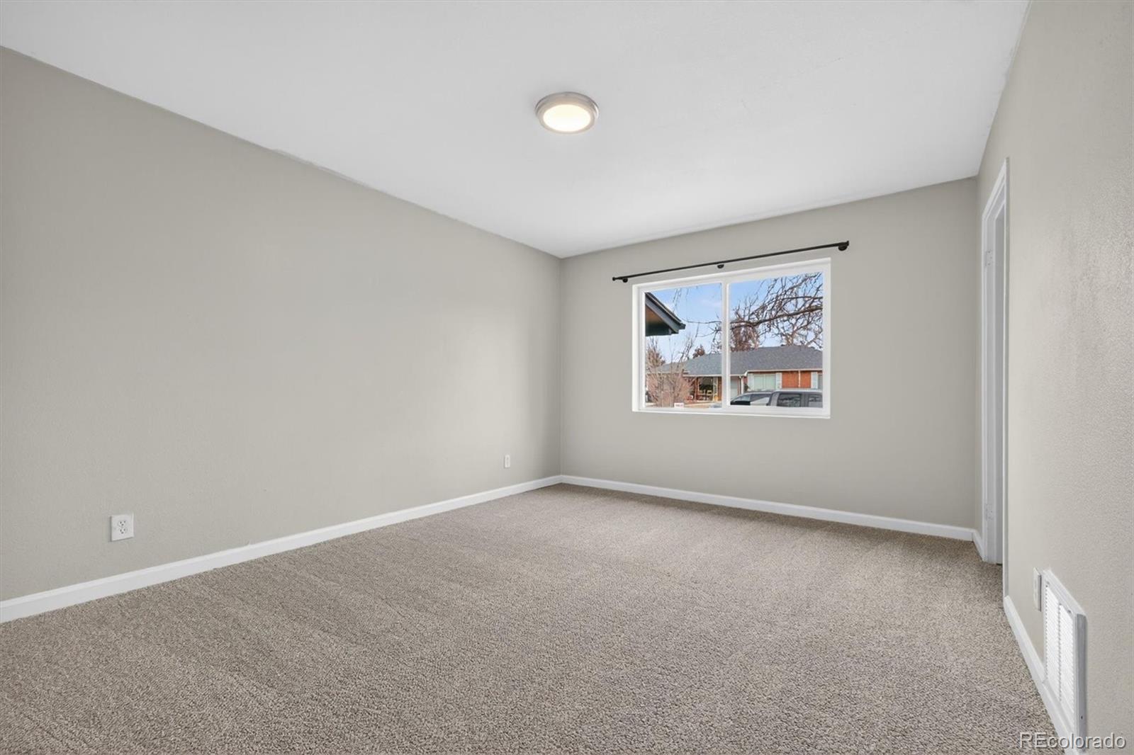 901 Racine Street Aurora, CO 80011 - Photo 21 of 29 an empty room with windows