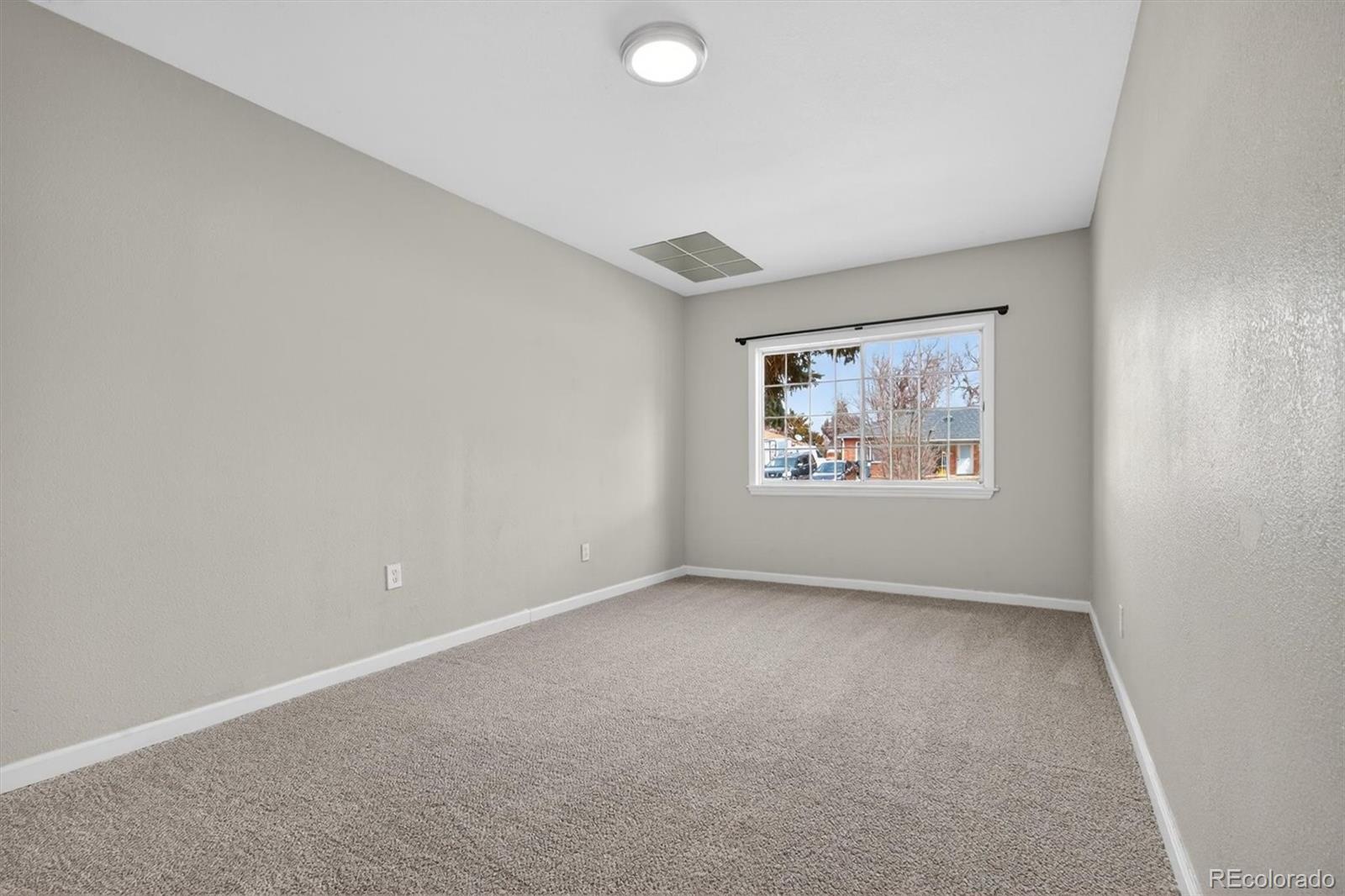 901 Racine Street Aurora, CO 80011 - Photo 23 of 29 an empty room with windows