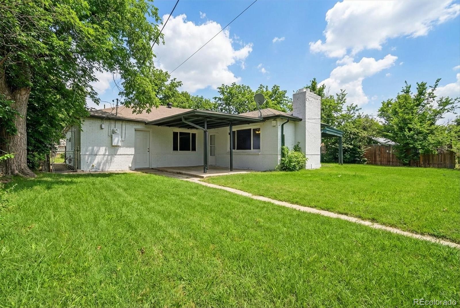 901 Racine Street Aurora, CO 80011 - Photo 24 of 29 a front view of house with yard and green space