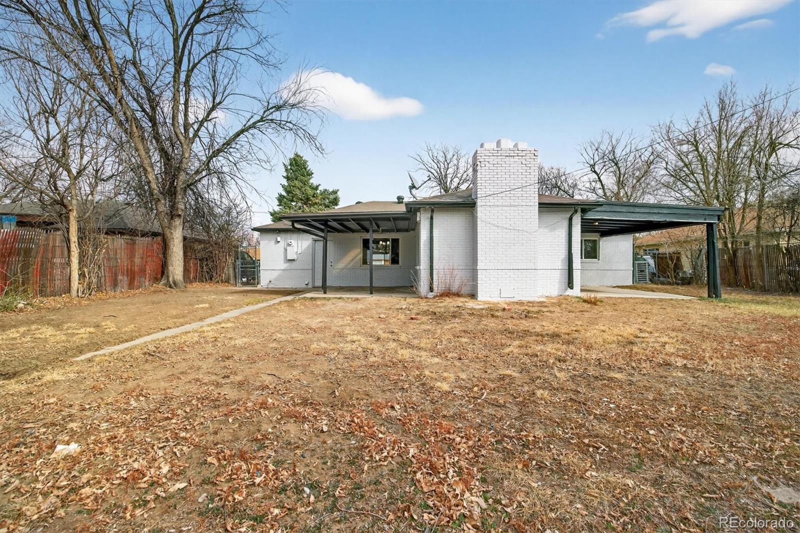 901 Racine Street Aurora, CO 80011 - Photo 27 of 29 a front view of a house with a yard and garage