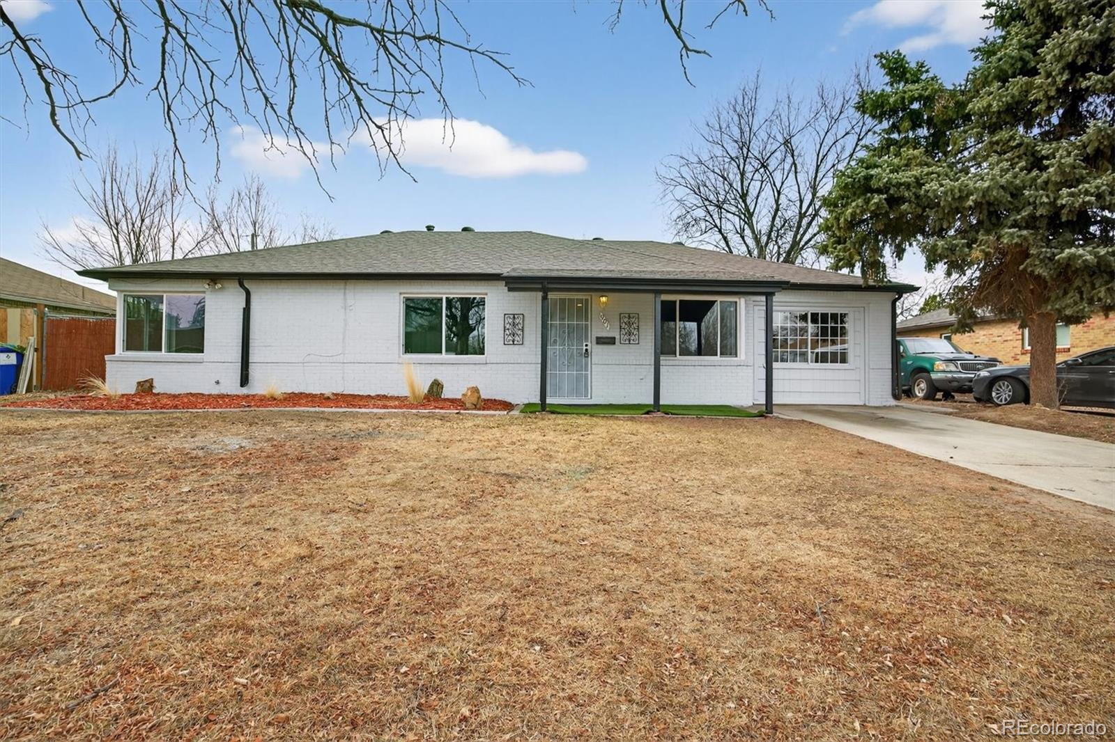 901 Racine Street Aurora, CO 80011 - Photo 3 of 29 a front view of a house with a yard