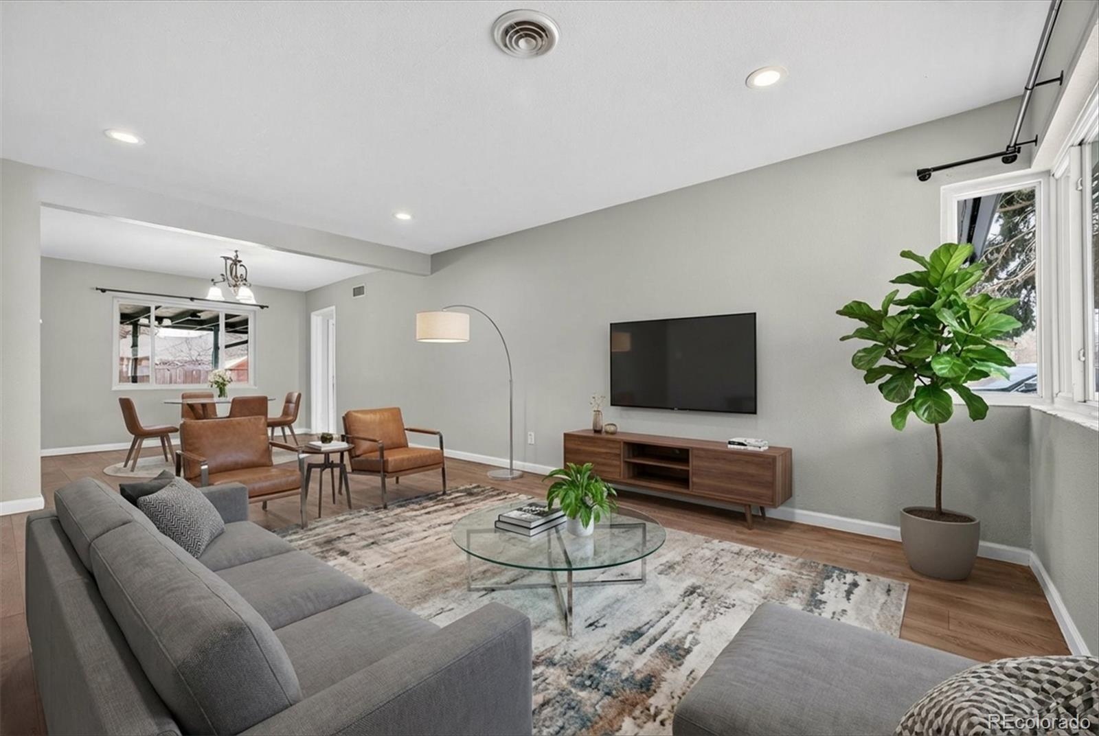 901 Racine Street Aurora, CO 80011 - Photo 5 of 29 a living room with furniture and a flat screen tv