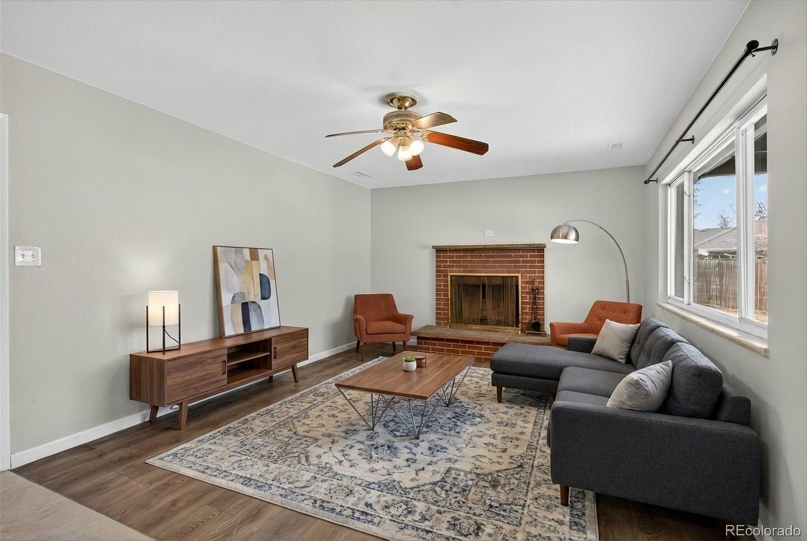 901 Racine Street Aurora, CO 80011 - Photo 10 of 29 a living room with furniture and a fireplace