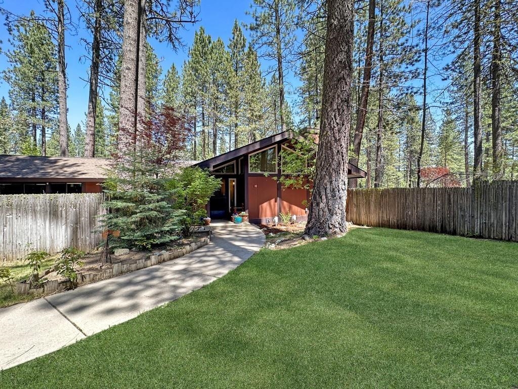 a view of a chair and table in backyard of the house
