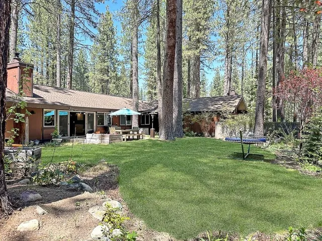a backyard of a house with table and chairs