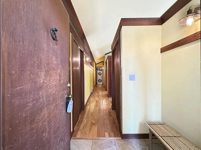 a view of hallway with wooden floor