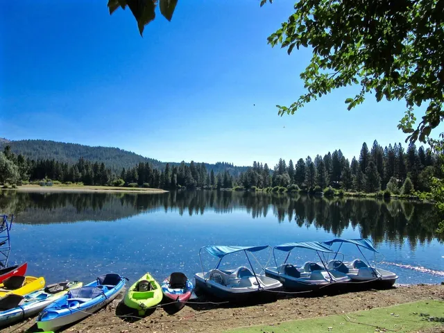 a view of a lake with a table and chairs