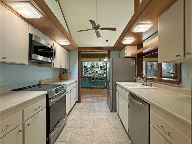 a kitchen with stainless steel appliances granite countertop a sink and stove top oven