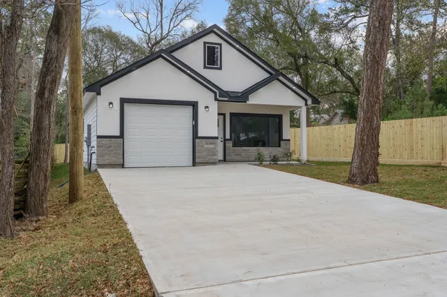 a view of a house with a yard and garage