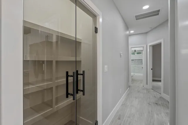 a view of walk in closet with empty racks