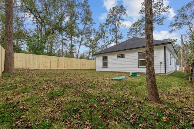 a view of a backyard with large trees