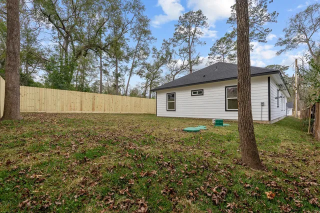 a view of a backyard with large trees