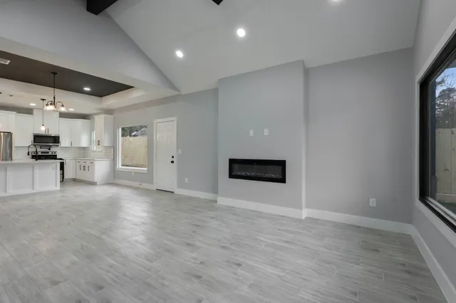 a view of an empty room with a kitchen