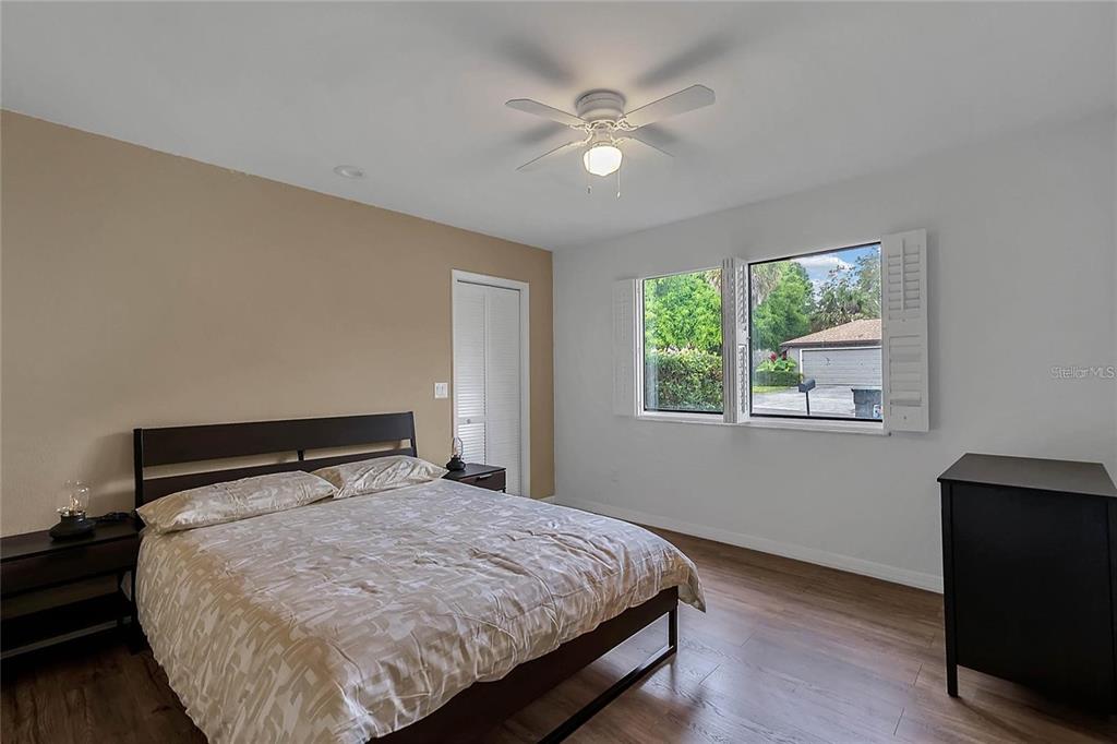 5607 Spring Run Avenue Orlando, FL 32819 - Photo 16 of 20 a bed sitting in a bedroom next to a window