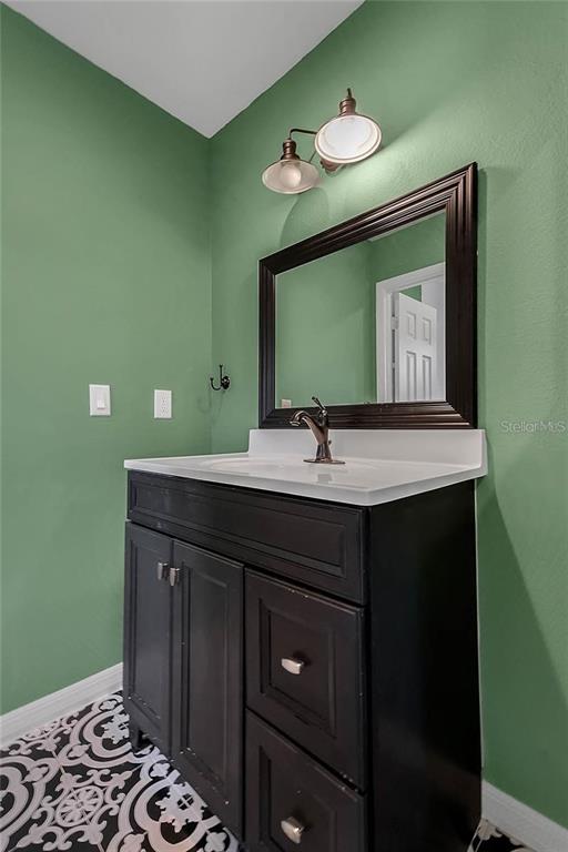5607 Spring Run Avenue Orlando, FL 32819 - Photo 17 of 20 a bathroom with a sink and a mirror