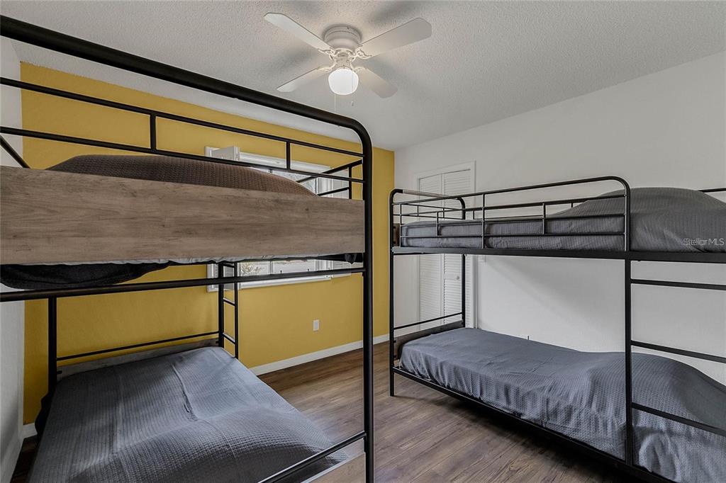5607 Spring Run Avenue Orlando, FL 32819 - Photo 19 of 20 a bedroom with a bed and wooden floor