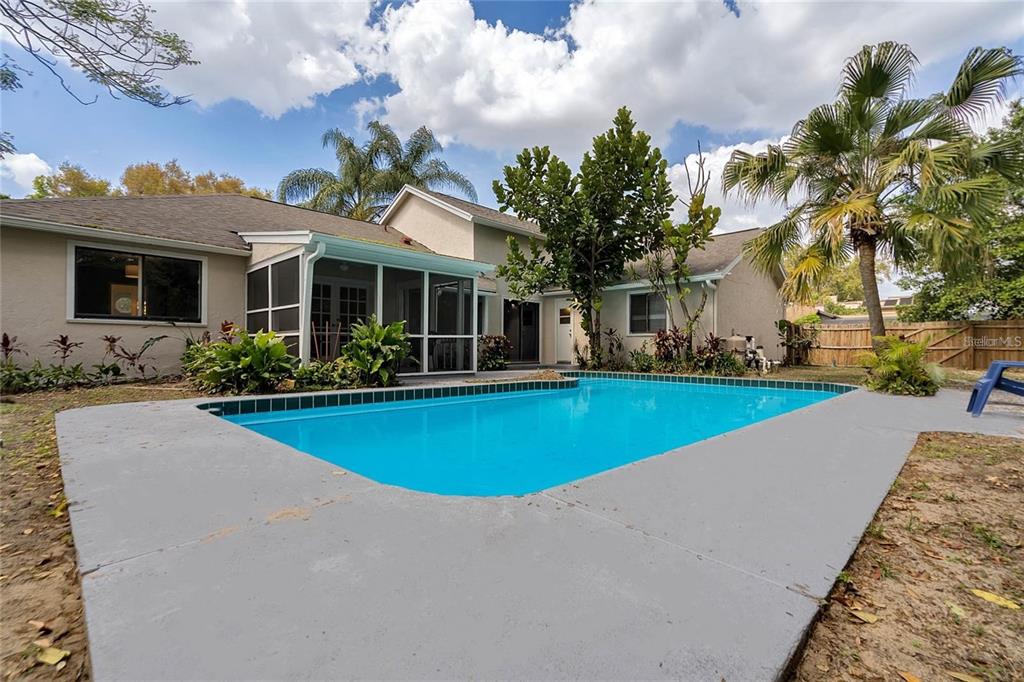 5607 Spring Run Avenue Orlando, FL 32819 - Photo 20 of 20 a view of a house with swimming pool and a garden