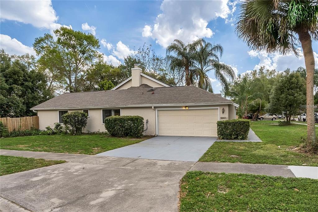 5607 Spring Run Avenue Orlando, FL 32819 - Photo 2 of 20 front view of a house with a yard