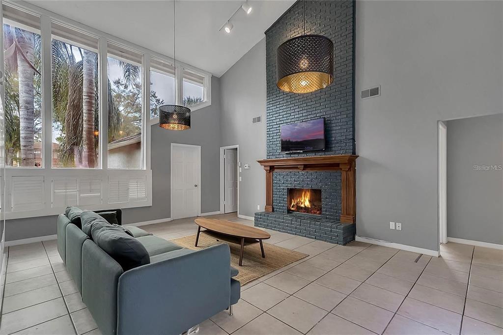 5607 Spring Run Avenue Orlando, FL 32819 - Photo 5 of 20 a living room with furniture and a fireplace