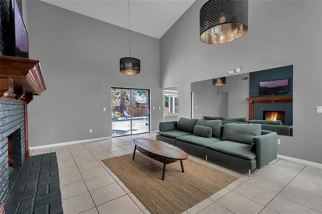 5607 Spring Run Avenue Orlando, FL 32819 - Photo 6 of 20 a living room with furniture and a fireplace
