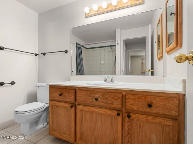 a bathroom with a toilet a sink and a mirror