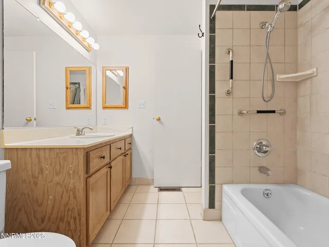 a bathroom with a tub sink mirror and a shower