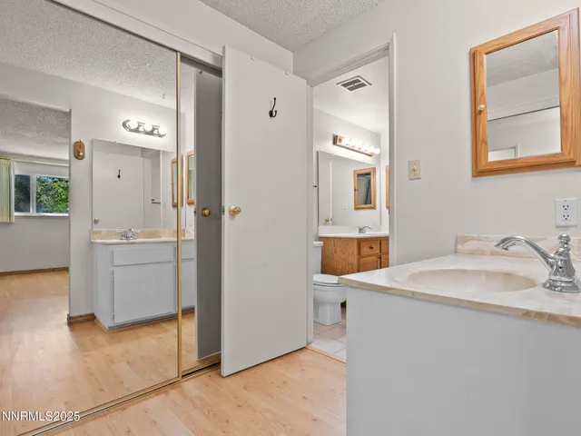 a bathroom with a sink a toilet and mirror
