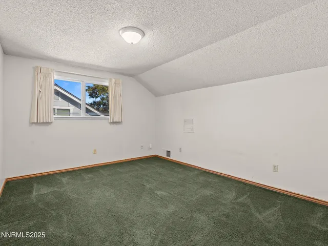 an empty room with a painting on the wall