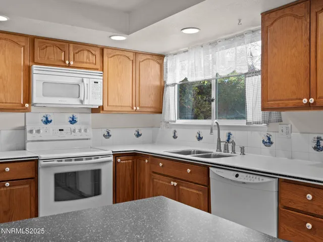 a kitchen with a sink stove top oven and cabinets