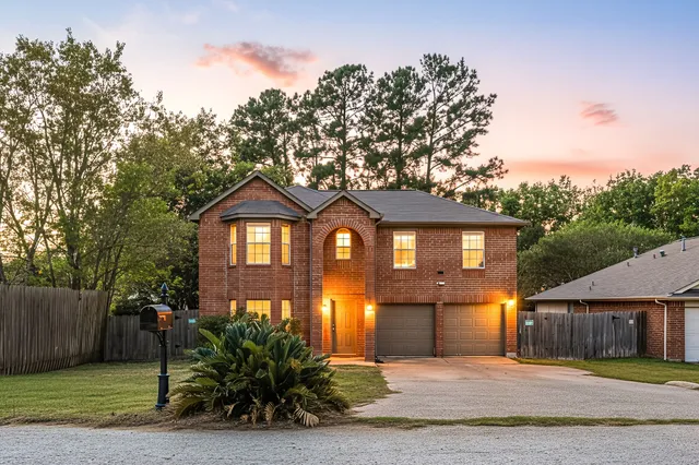 a front view of a house with a yard and a garage