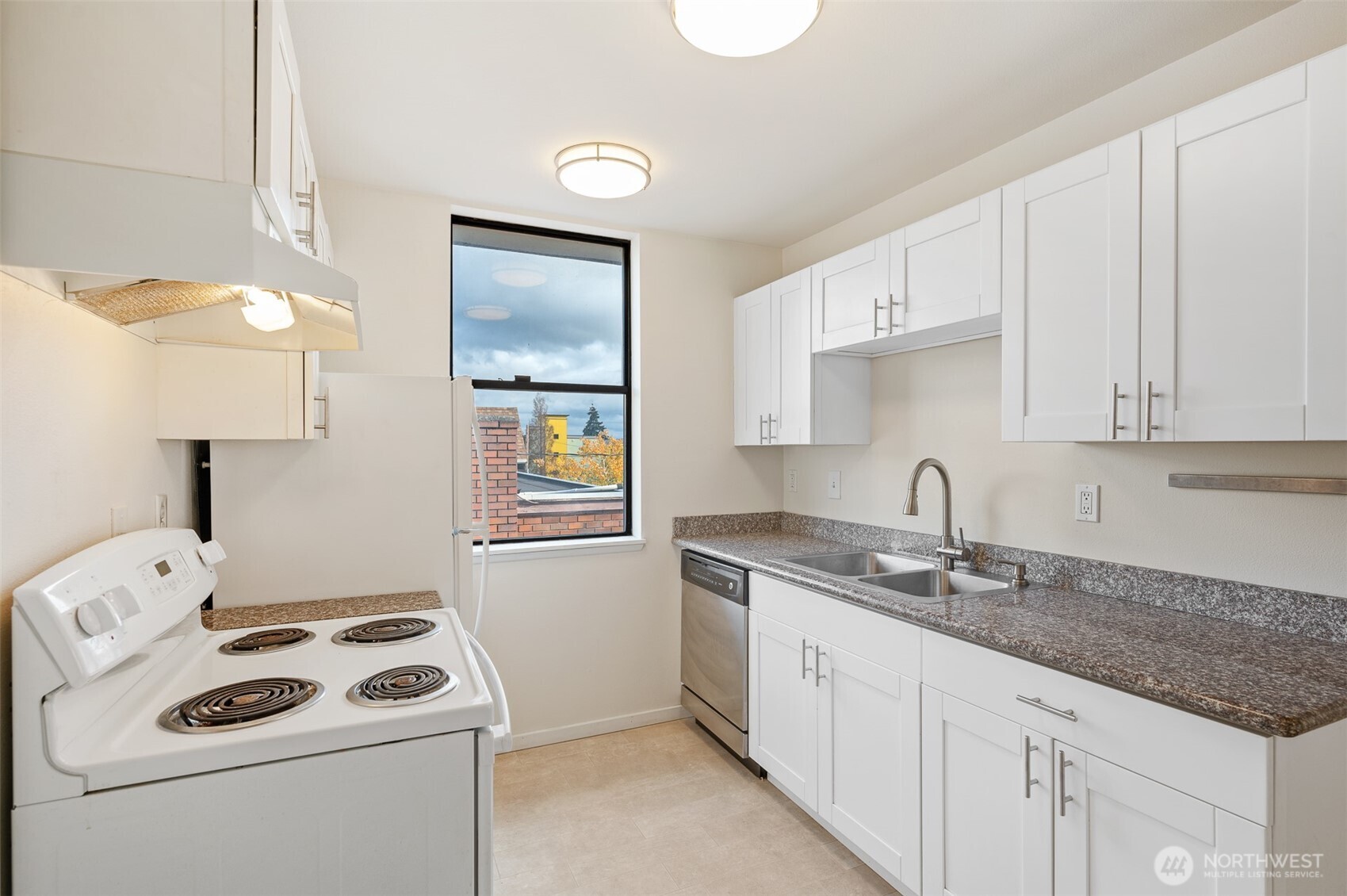 802 North 43rd Street Seattle, WA 98103 - Photo 12 of 18 a kitchen with sink cabinets and stove