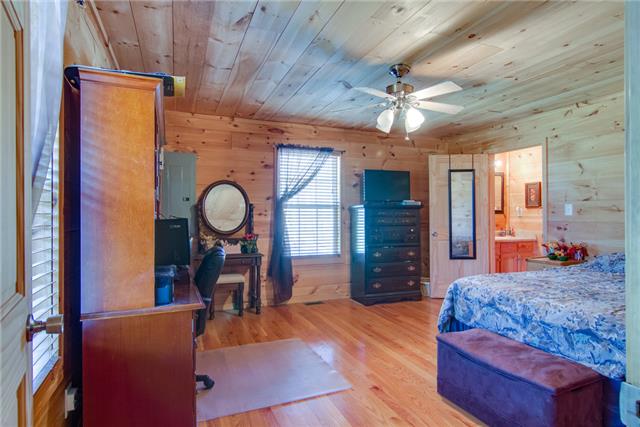8813 West Sheepneck Road Mount Pleasant, TN 38474 - Photo 11 of 19 MASTER BEDROOM WITH HARDWOOD FLOORS AND MASTER BATH