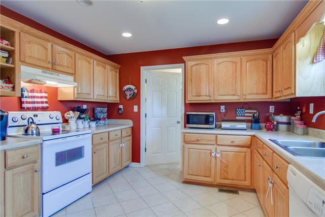 8813 West Sheepneck Road Mount Pleasant, TN 38474 - Photo 10 of 19 KITCHEN HAS TILE FLOOR AND GORGEOUS CABINETS FOR STORAGE AND COUNTER TOPS FOR PREP WORK