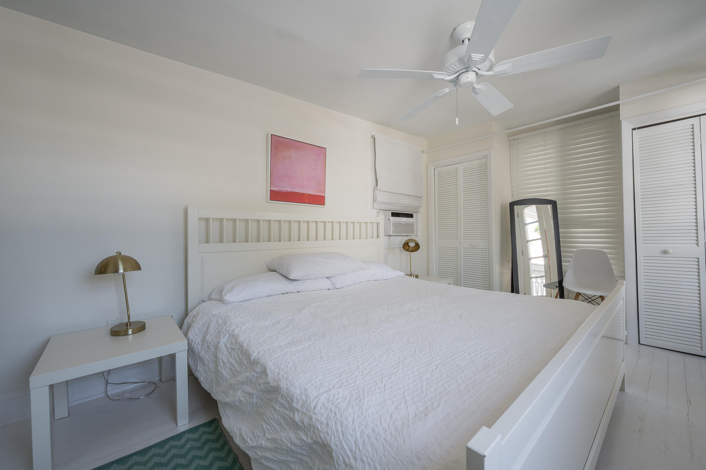 609 1/2 Margaret Street Key West, FL 33040 - Photo 11 of 35 a bedroom with a bed and a chandelier