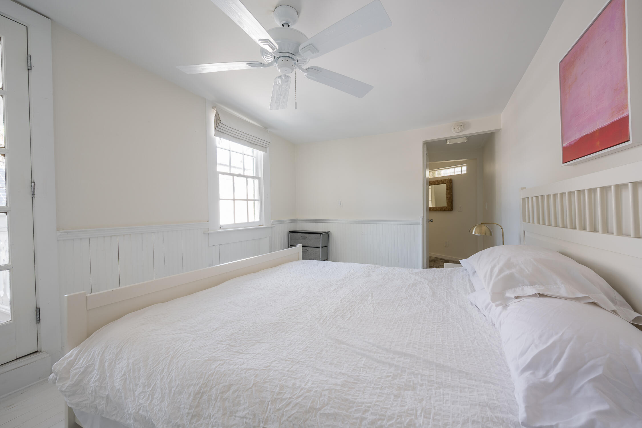 609 1/2 Margaret Street Key West, FL 33040 - Photo 13 of 35 a bedroom with a large bed and a chandelier