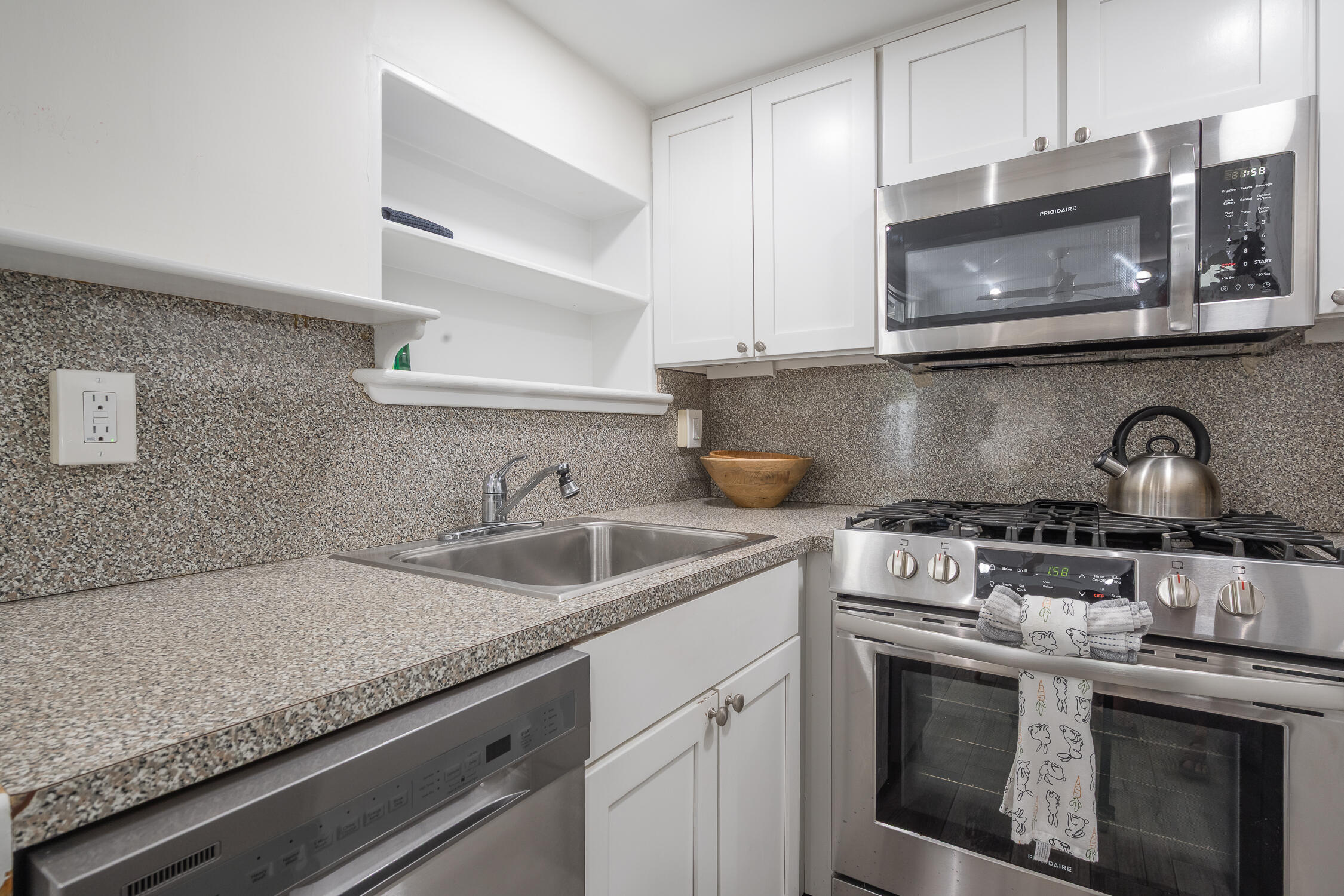 609 1/2 Margaret Street Key West, FL 33040 - Photo 5 of 35 a kitchen with granite countertop a sink stove and microwave
