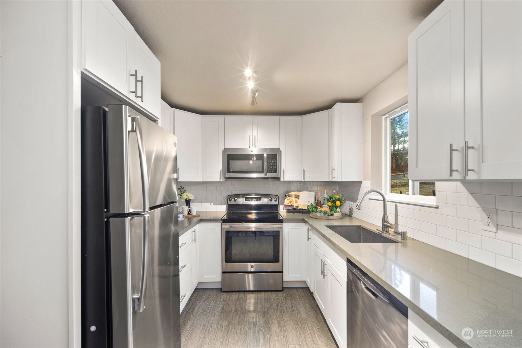 14322 Three Lakes Road Snohomish, WA 98290 - Photo 10 of 36 a kitchen with stainless steel appliances a refrigerator sink and white cabinets