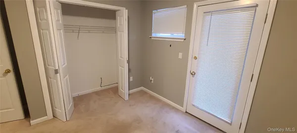 a view of an empty room and closet area