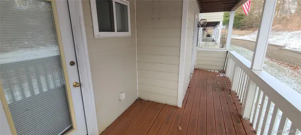 a view of walk in closet with wooden floor