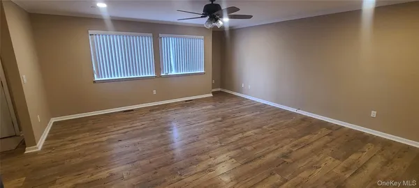 wooden floor in an empty room with a window
