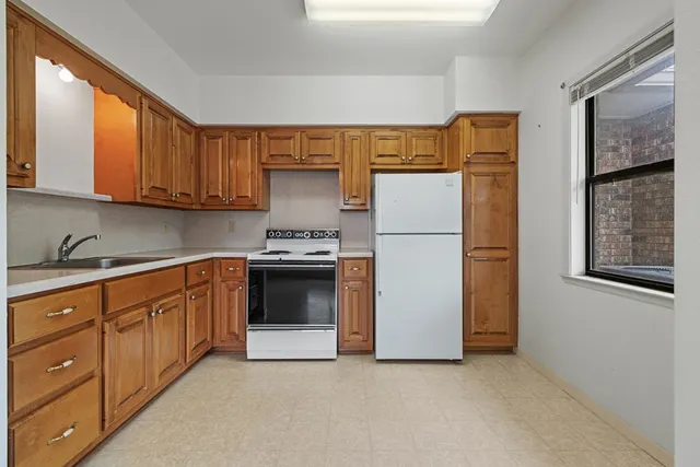 a bedroom with a bed and a lamp