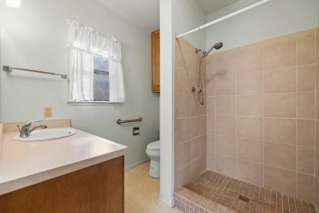 a bathroom with a sink toilet and shower