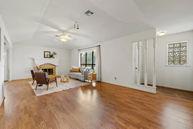 a living room with furniture and wooden floor