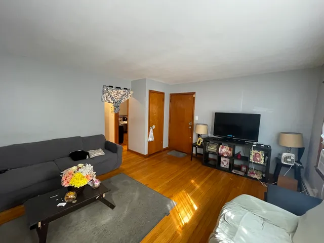 a gym room with furniture a chandelier and a window